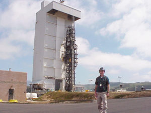 Dick Quinn stands in front of launch platform.